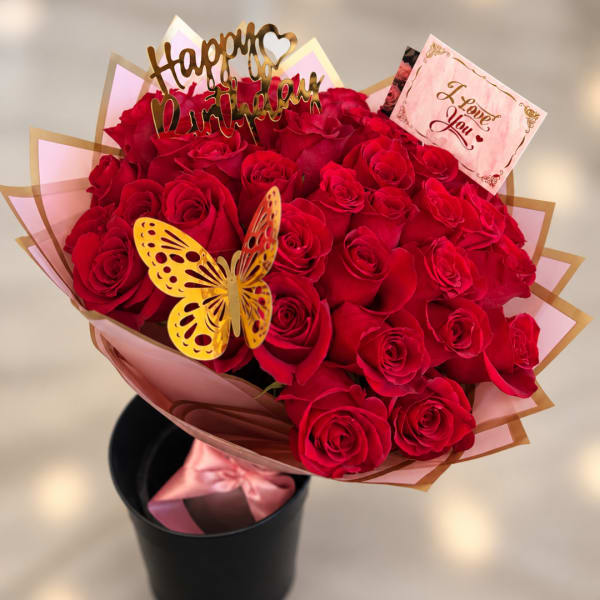 Bouquet of red roses with a butterfly topper and gift cards