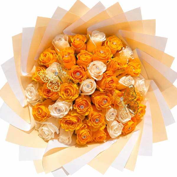 Bouquet of orange and cream roses wrapped in layered paper