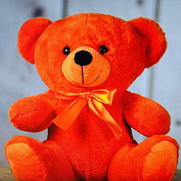 Orange teddy bear with a ribbon bow