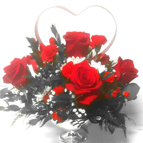 Red roses and carnations in a silver vase with a heart-shaped handle