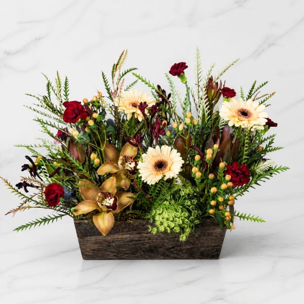 Mixed floral arrangement in a wooden rectangular container