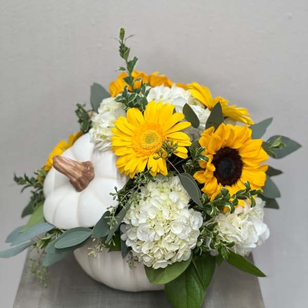 White pumpkin arrangement with yellow sunflowers and white hydrangeas