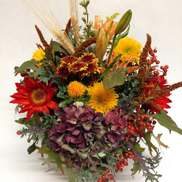 Autumn bouquet with red and yellow flowers and purple hydrangea