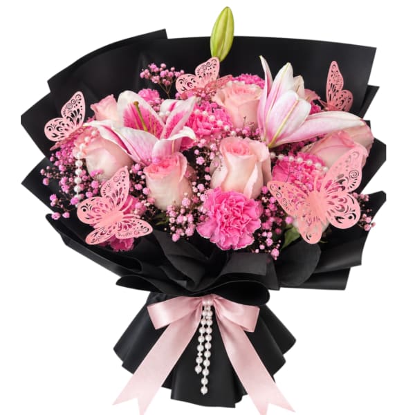 Pink bouquet with lilies, roses, and carnations wrapped in black paper