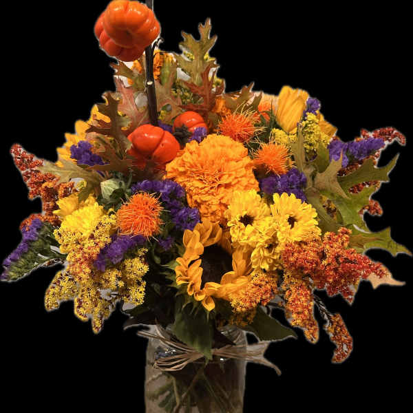 Autumn bouquet of sunflowers, chrysanthemums, and orange pumpkins in a glass vase