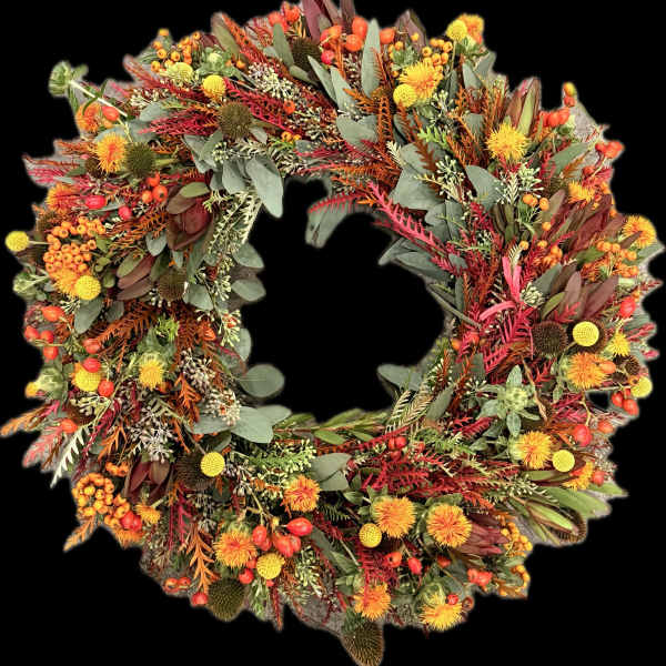 Autumn wreath with orange and yellow flowers and mixed foliage