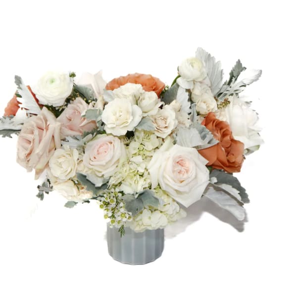 White and blush rose bouquet in a gray vase