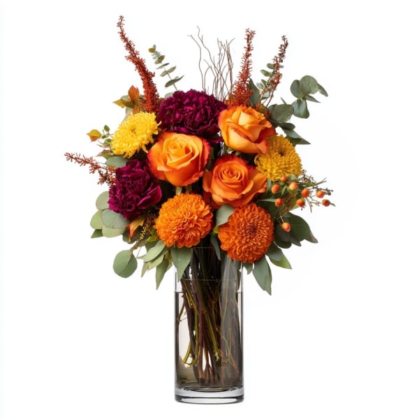 Orange and purple flower arrangement in a clear glass vase