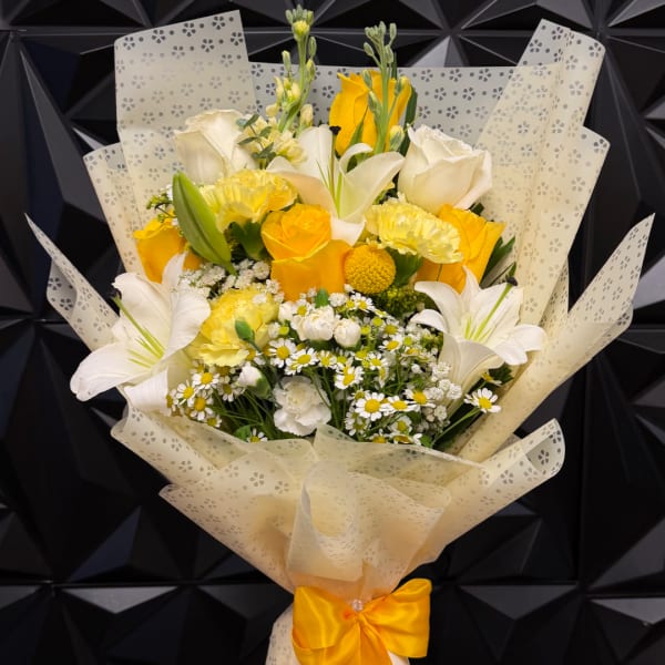 Yellow and white mixed bouquet wrapped in patterned paper