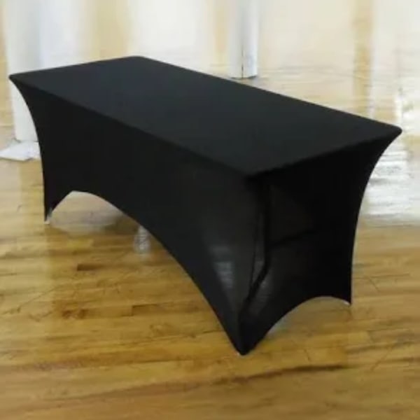 Black rectangular event table cover on a wooden floor