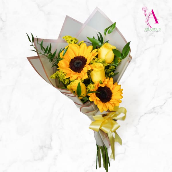 Yellow sunflower and rose bouquet wrapped in paper with a ribbon