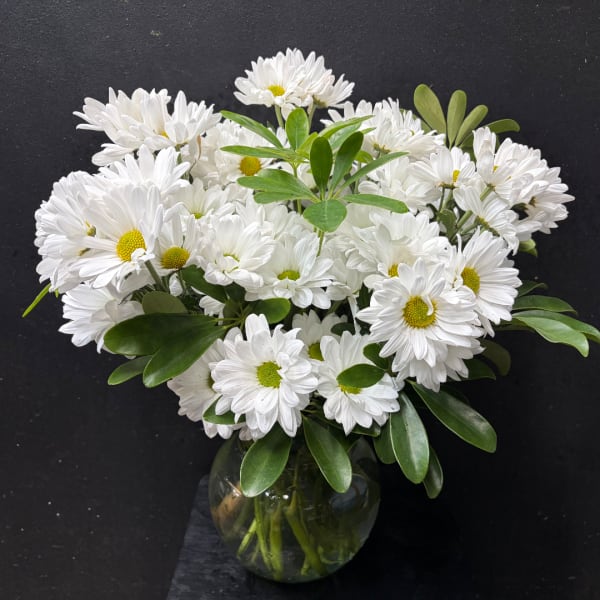 White daisy bouquet in a round glass vase