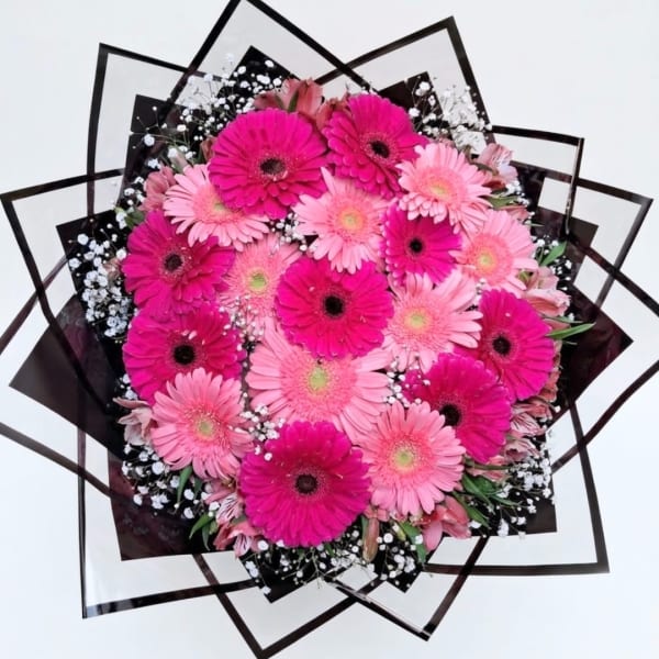 Pink and magenta gerbera daisy bouquet with black wrap