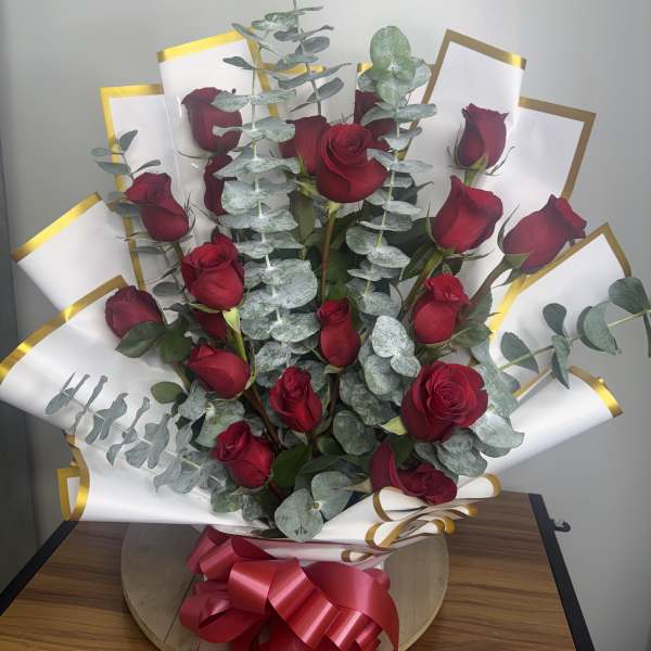 Bouquet of red roses with eucalyptus and white-gold wrap