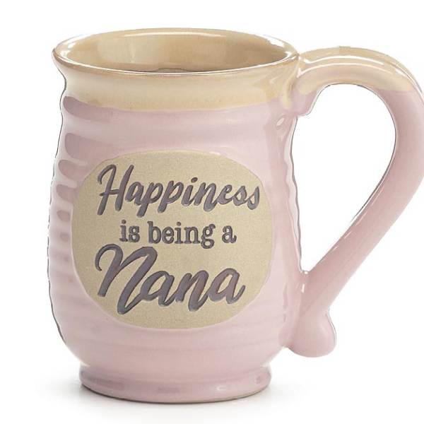 Pink ceramic mug with beige rim and oval plaque reading “Happiness is being a Nana.”