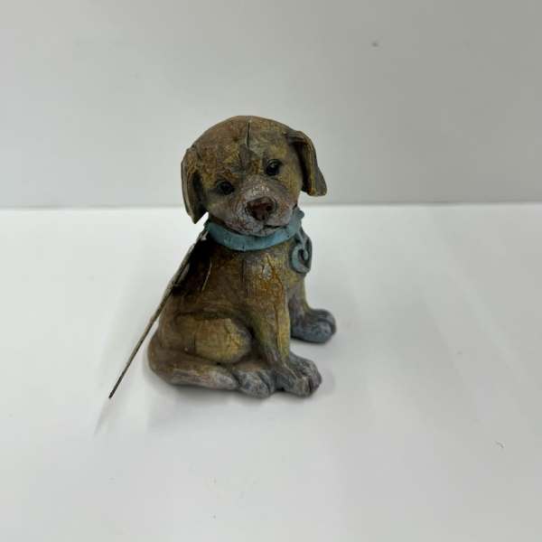 Small decorative dog figurine with a blue collar