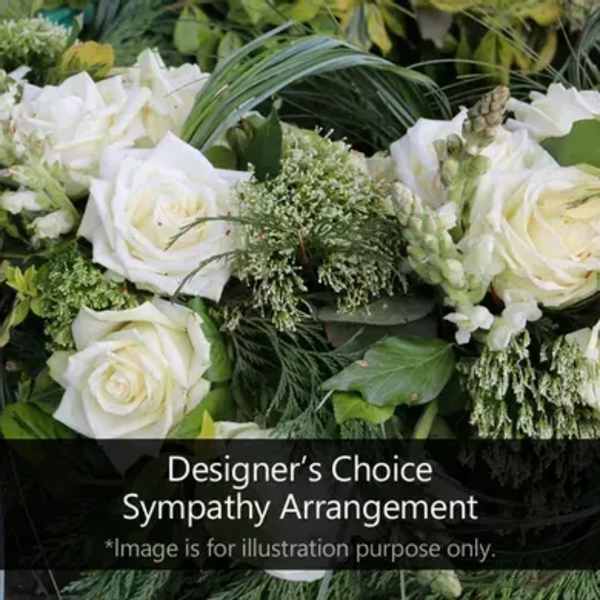 White roses and green filler flowers in a sympathy arrangement