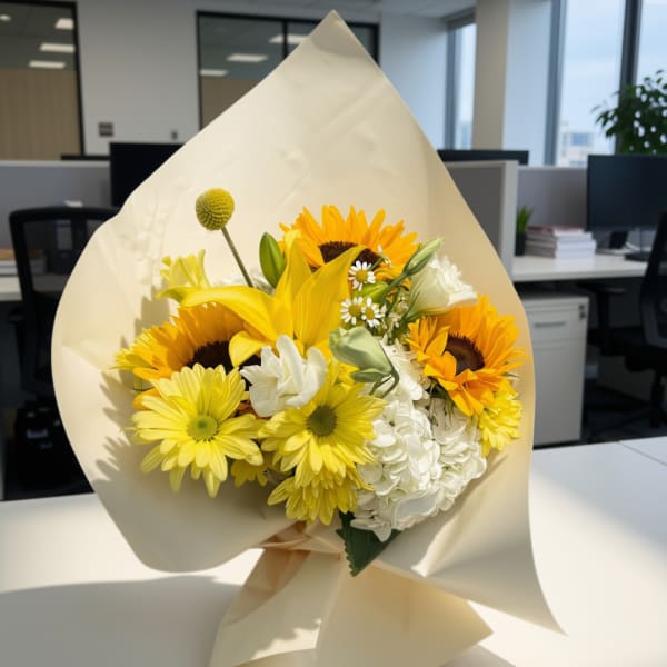 Bouquet of yellow sunflowers and white flowers wrapped in cream paper