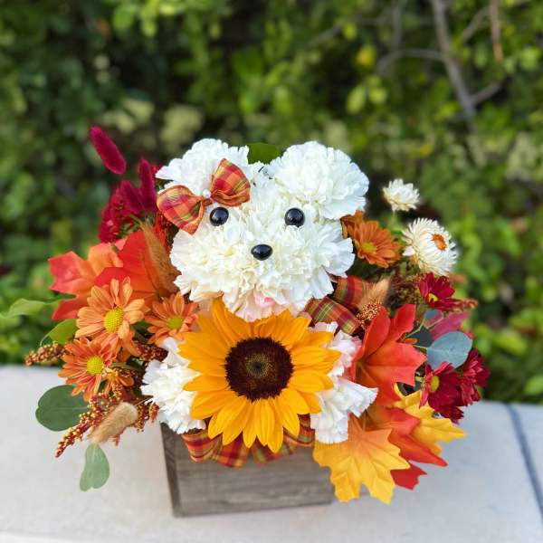 Flower arrangement shaped like a teddy bear with a sunflower face
