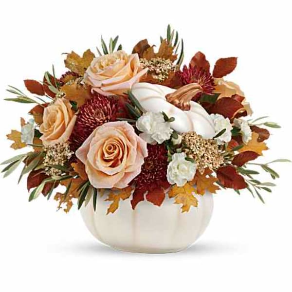 Peach roses and white flowers in a white pumpkin vase