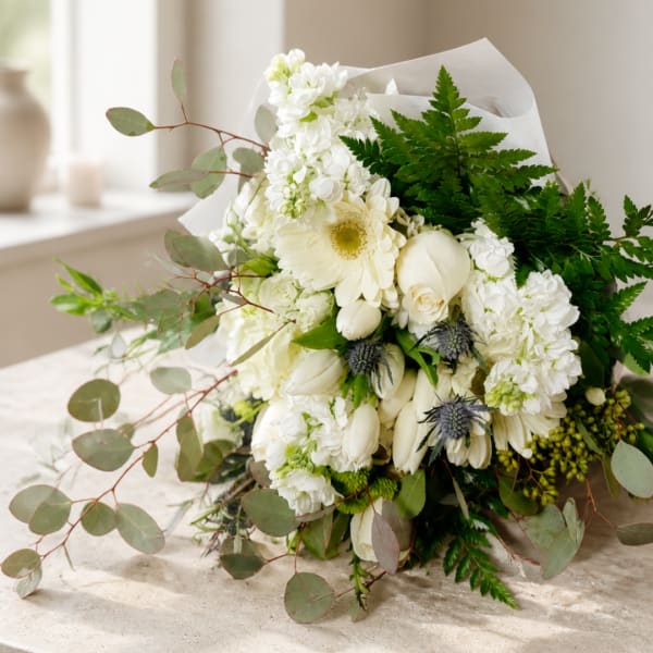White bouquet with gerbera daisies, roses, and hydrangeas