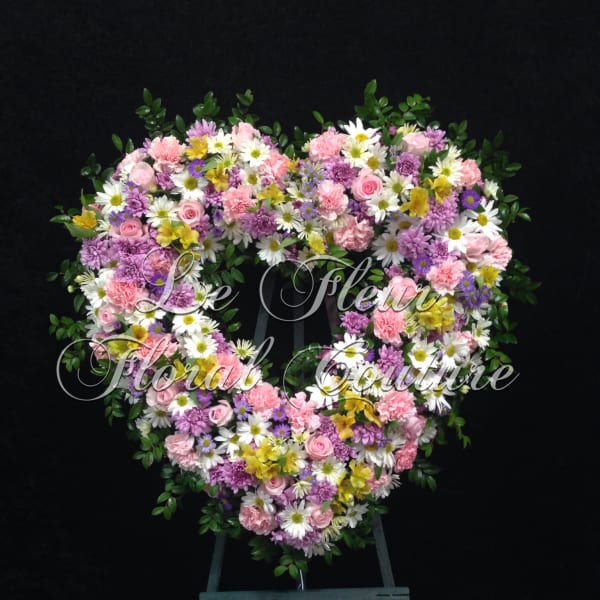 Heart-shaped floral wreath with pink, white, purple, and yellow blooms
