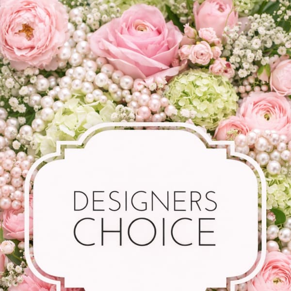 Pink and green floral arrangement with pearl accents and a "Designers Choice" sign