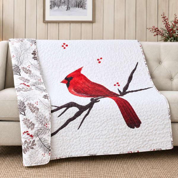 Quilted throw blanket with a red cardinal and berry branch pattern