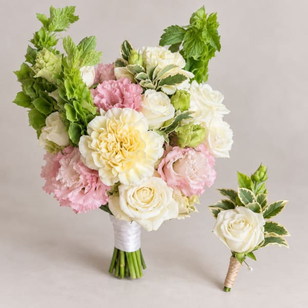Bouquet of white roses, pink carnations, and green blooms with a matching boutonniere