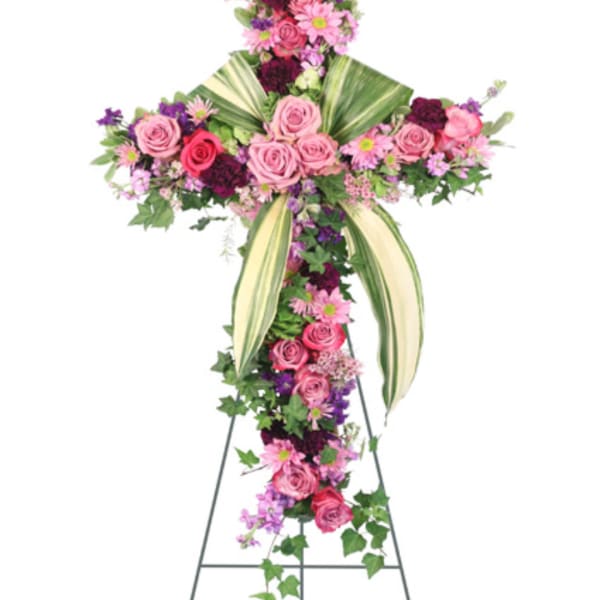 Standing floral spray with pink and purple roses and daisies on an easel