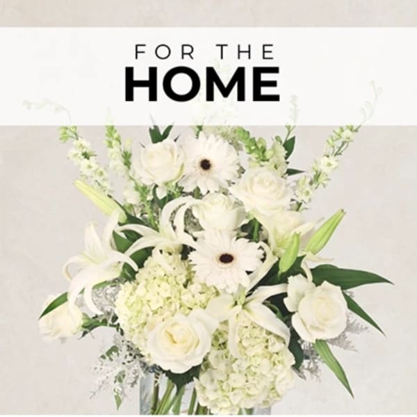 White floral arrangement with roses, lilies, and daisies in a vase
