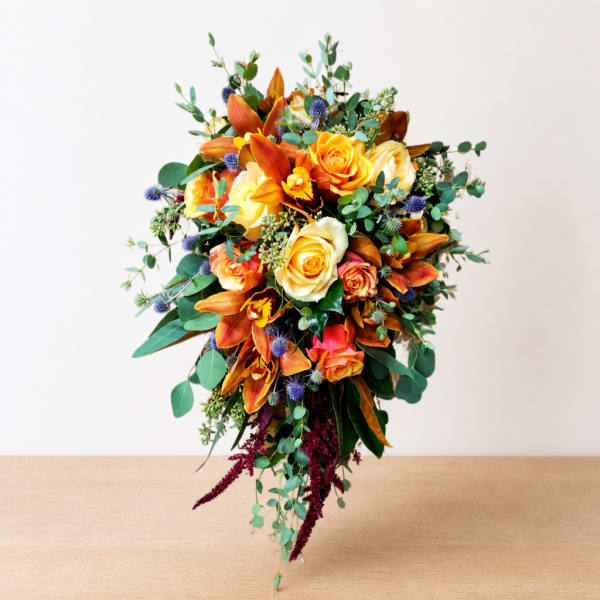 Wedding bouquet with orange lilies and yellow roses