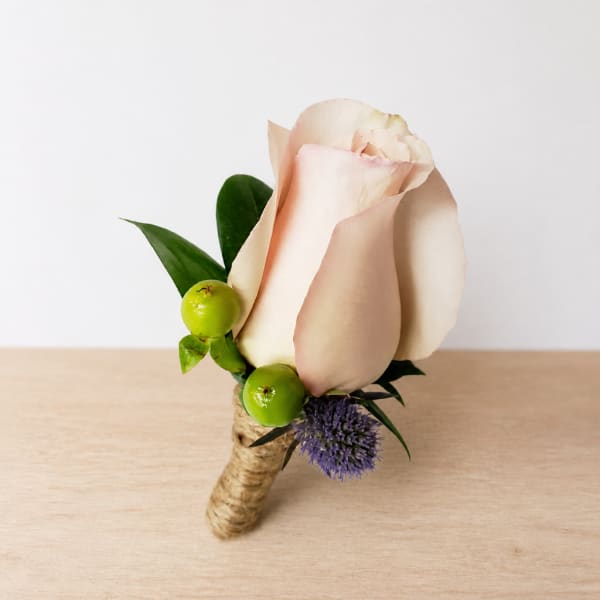 Single pale pink rose boutonniere with green berries and purple accent flower