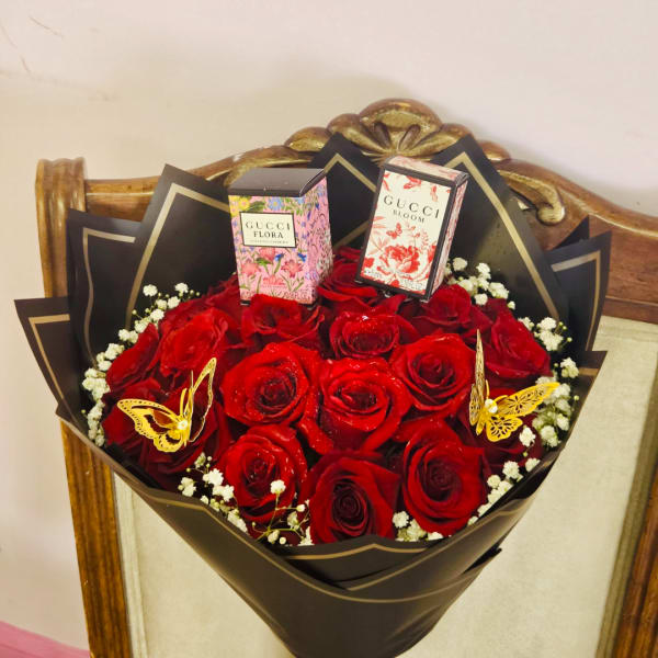 Bouquet of red roses with two perfume boxes and butterfly decorations