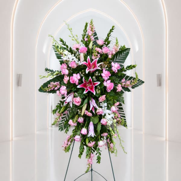 Tall pink and white floral standing spray on an easel