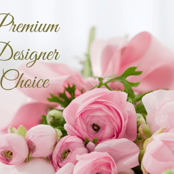 Pink ranunculus bouquet with green accents and the words Premium Designer Choice