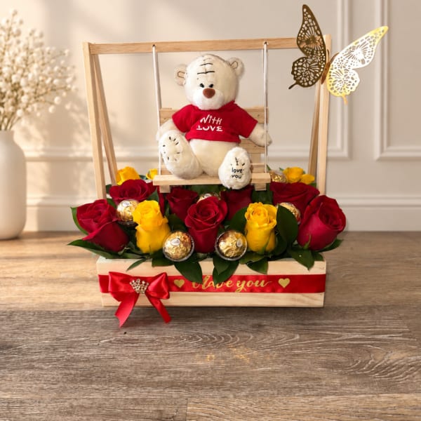 Red and yellow roses with a teddy bear in a wooden gift box