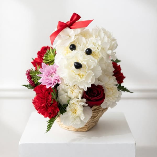 Flower arrangement shaped like a teddy bear in a wicker basket with a red bow
