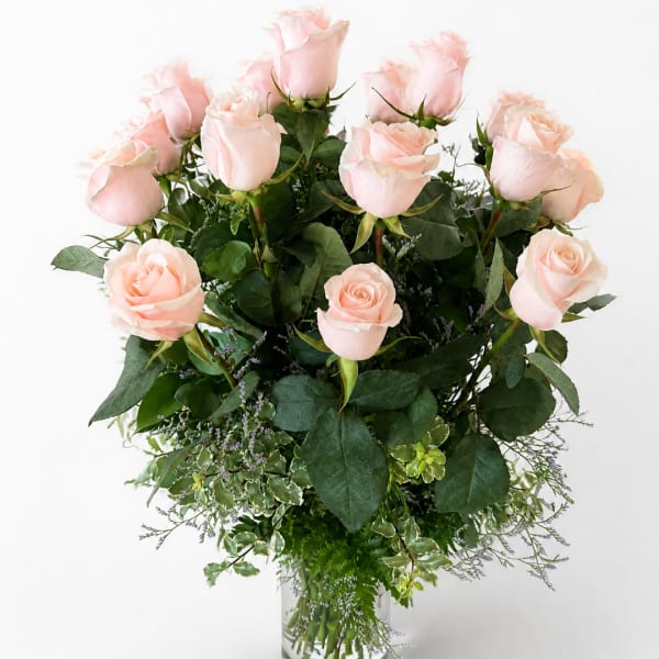 Bouquet of pale pink roses in a clear glass vase