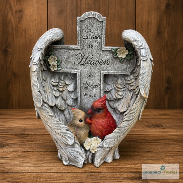Angel-wing memorial cross with two birds and small flowers