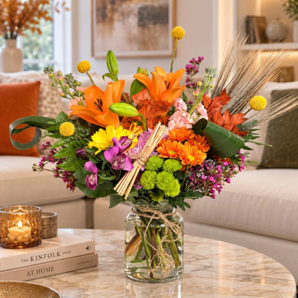 Colorful mixed bouquet in a glass vase on a table