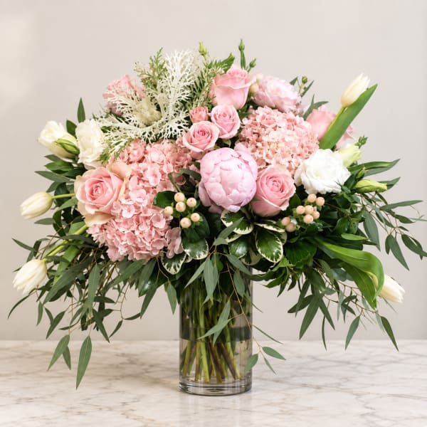Pink and white floral arrangement in a clear glass vase