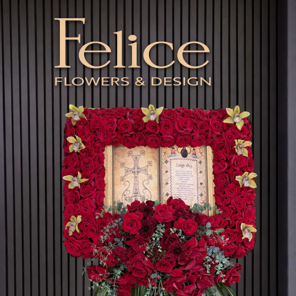 Standing floral easel with red roses and orchids around a framed tribute