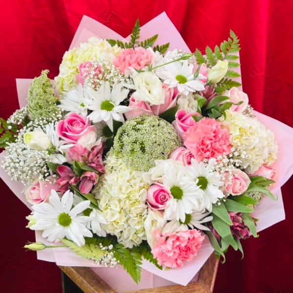 Pink and white mixed bouquet with daisies, roses, and carnations
