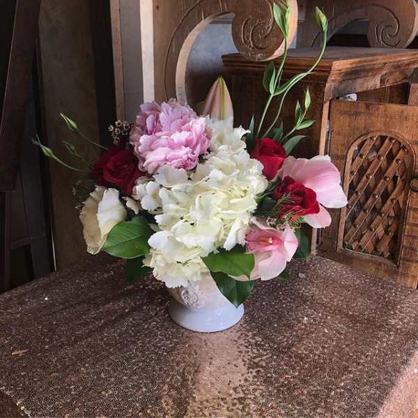 Pink and white floral arrangement in a white vase