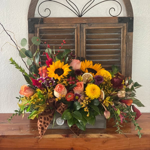 Mixed bouquet with sunflowers, roses, and mums in a wooden box