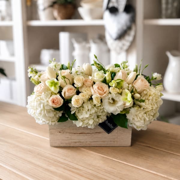 Cream and blush flower arrangement in a wooden box