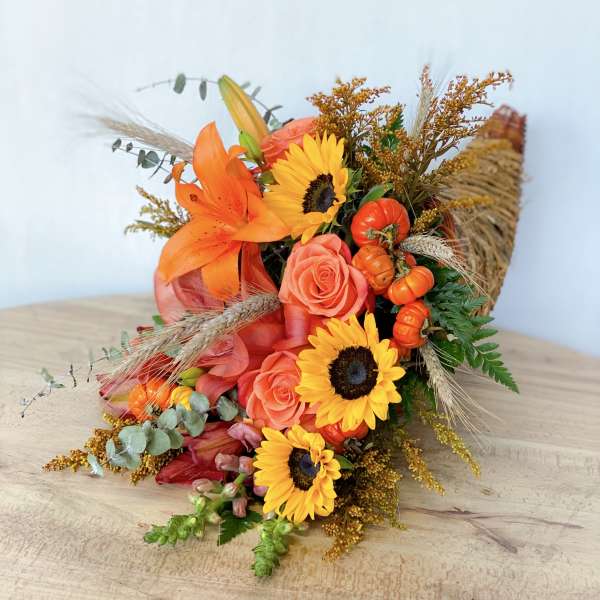 Orange and yellow bouquet with roses, sunflowers, and lilies