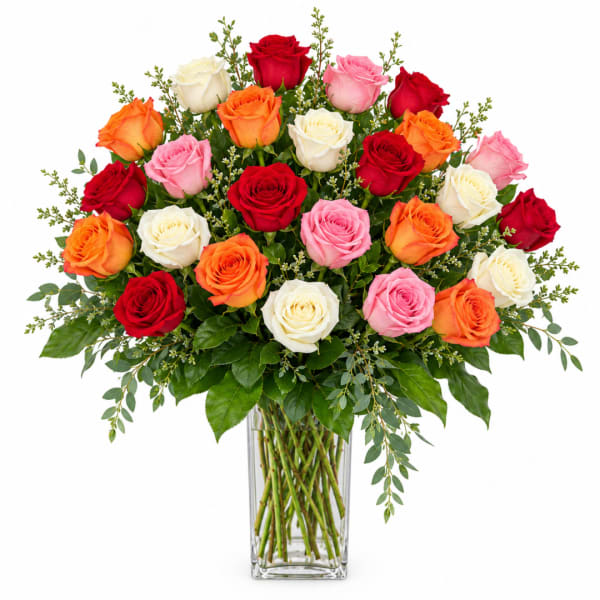 Mixed roses in red, pink, orange, and white in a clear glass vase