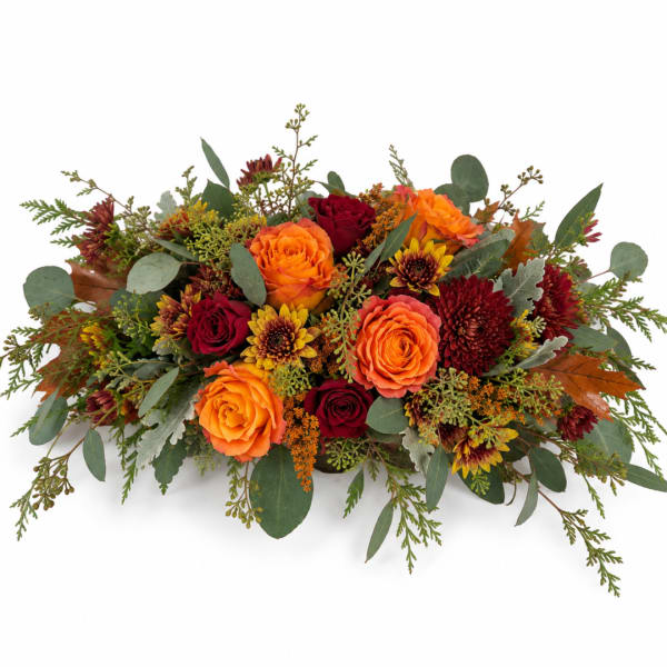 Low floral arrangement with orange and red roses and autumn mums